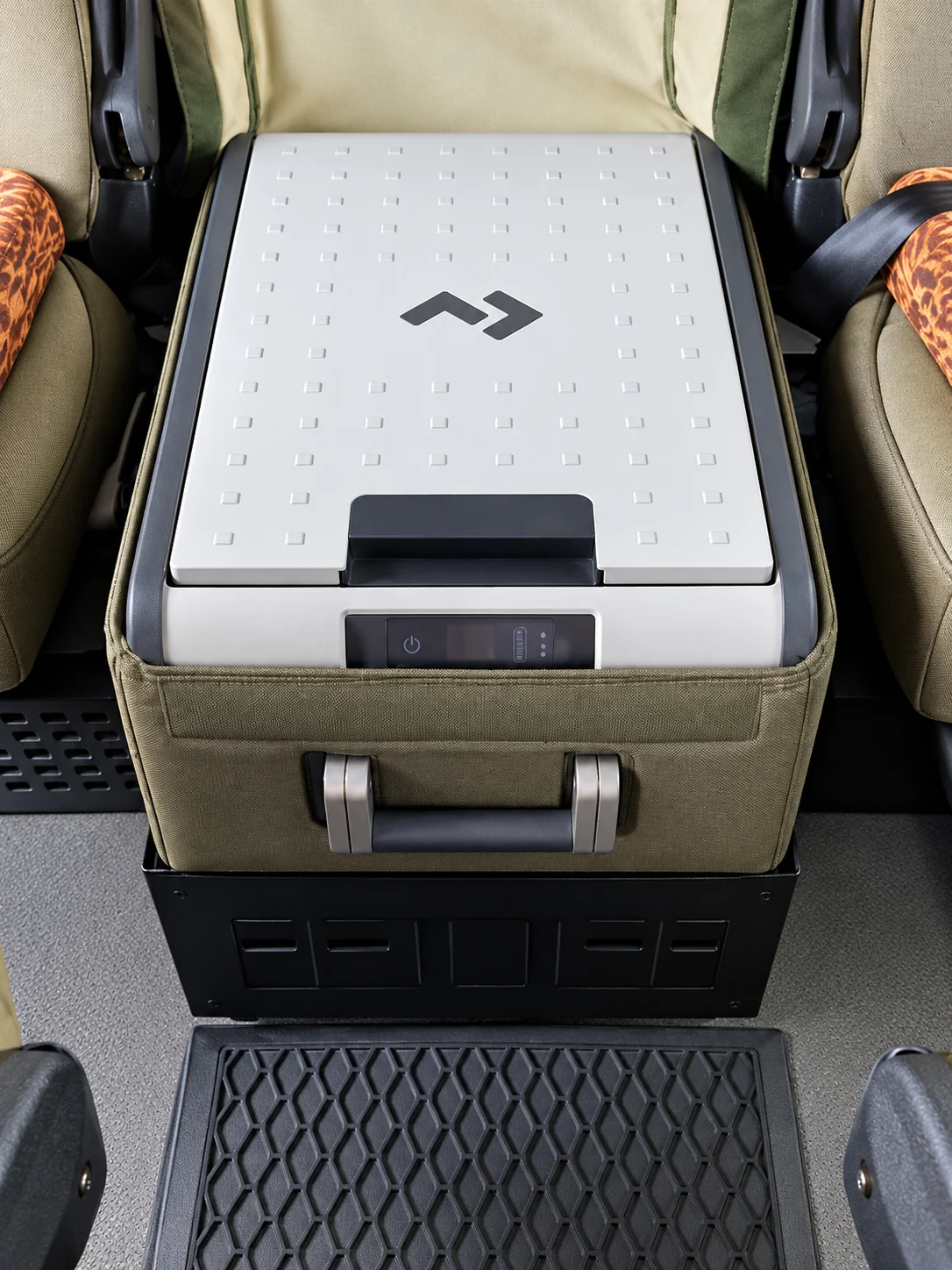 The onboard fridge between the passenger seats